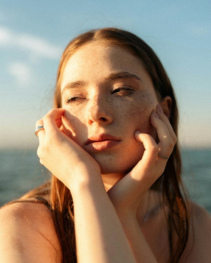 Woman with freckles in warm golden light