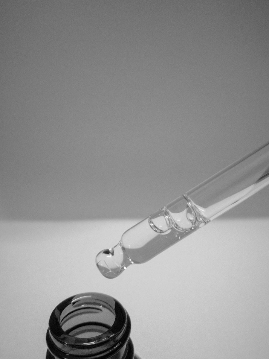 Glass pipette above a serum bottle